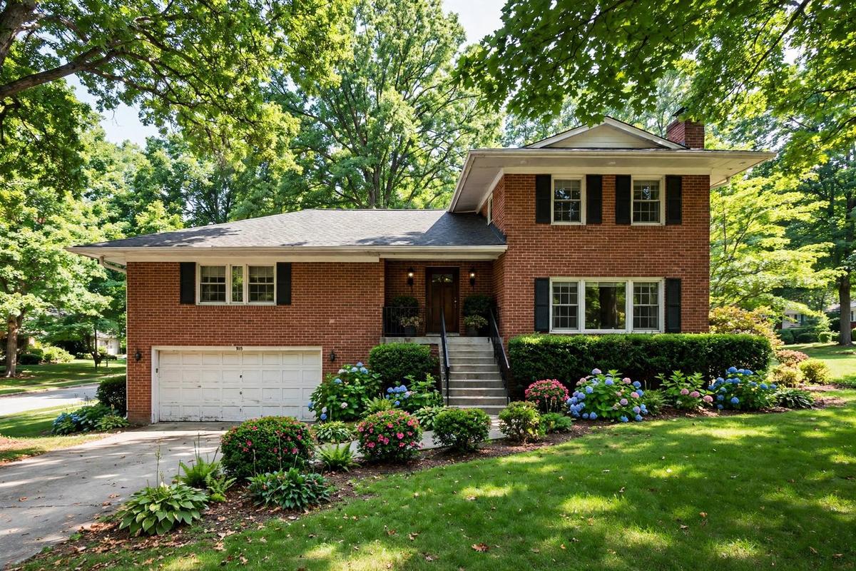 Exterior of an upscale colonial suburban home in Vienna, Virginia with a manicured lawn on a clear day.