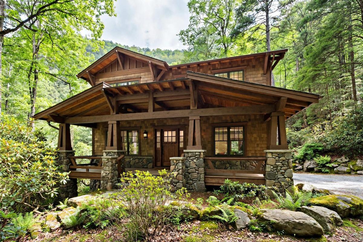 A craftsman home in Arden with a stone foundation, timber porch columns and native plantings in the Blue Ridge foothills.
