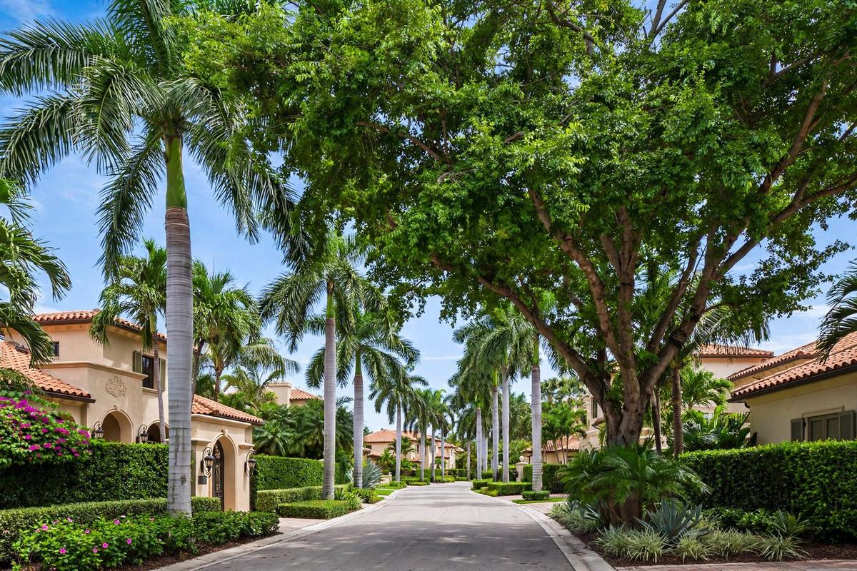 Street scene in Boca Raton Riviera, Florida, with established homes along a waterfront neighborhood street