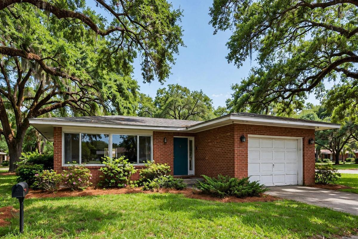 Mid-century ranch home in Spring Branch, Houston with a low-pitched roof and native landscaping.