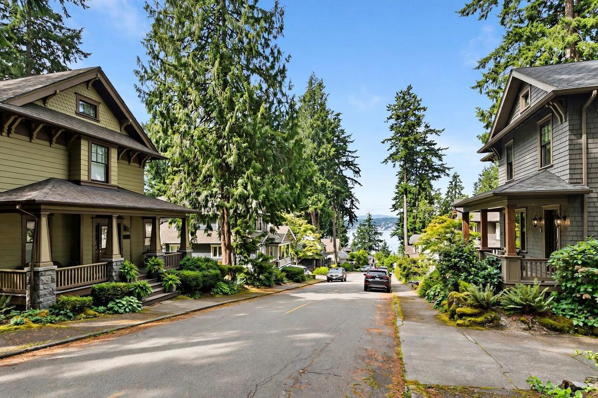 Photorealistic view of an upscale residential street in Kirkland, Washington, near the Lake Washington shoreline with an evergreen canopy and ranch homes.